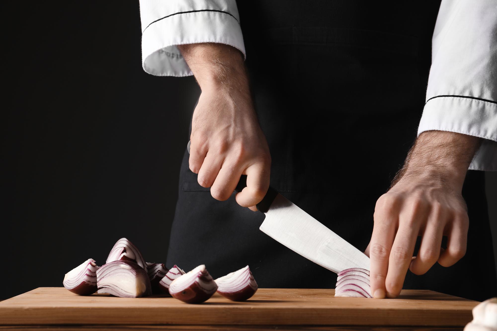 Chef demonstrating technique with hands and knife